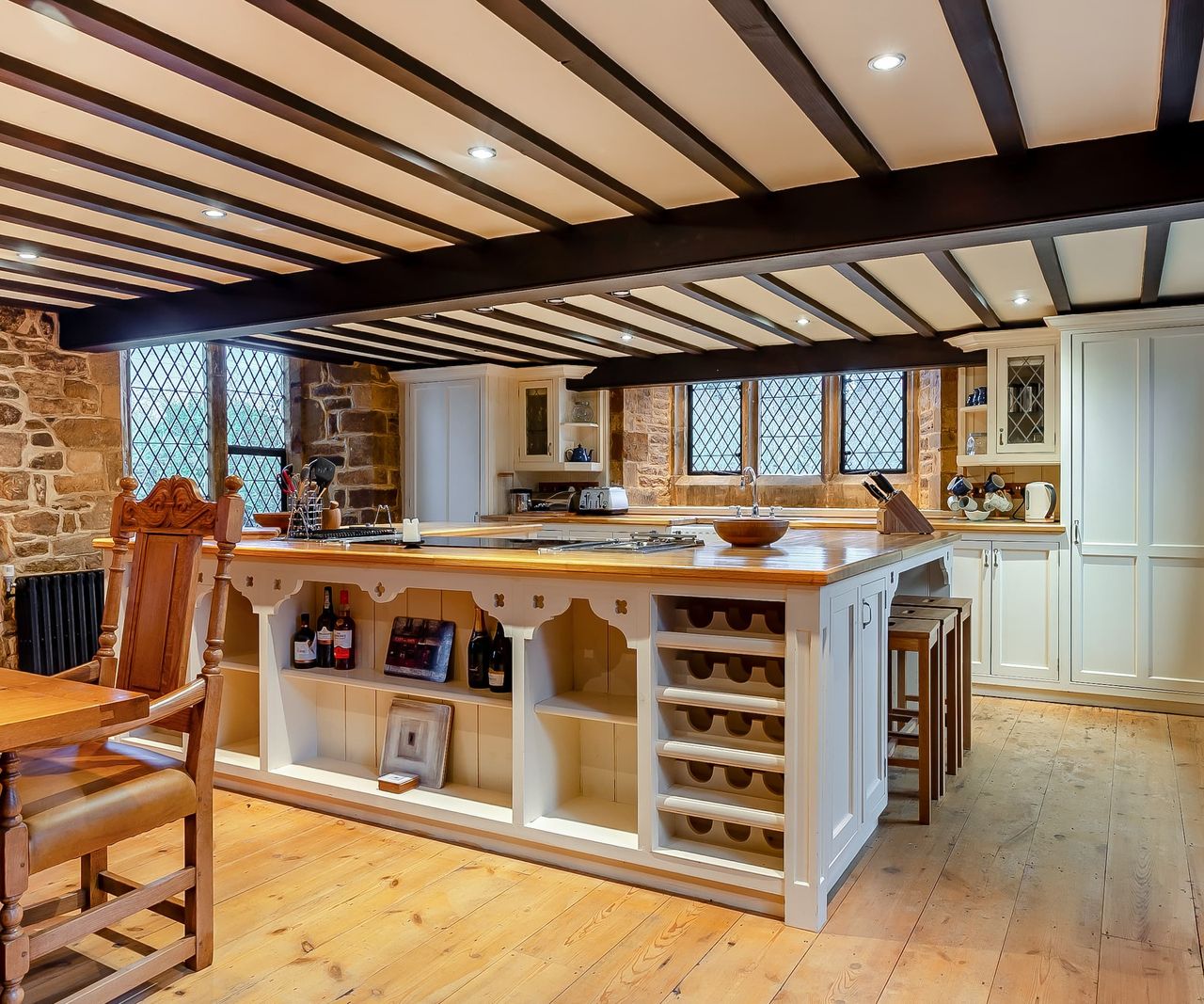 A white kitchen island with bespoke fitted units