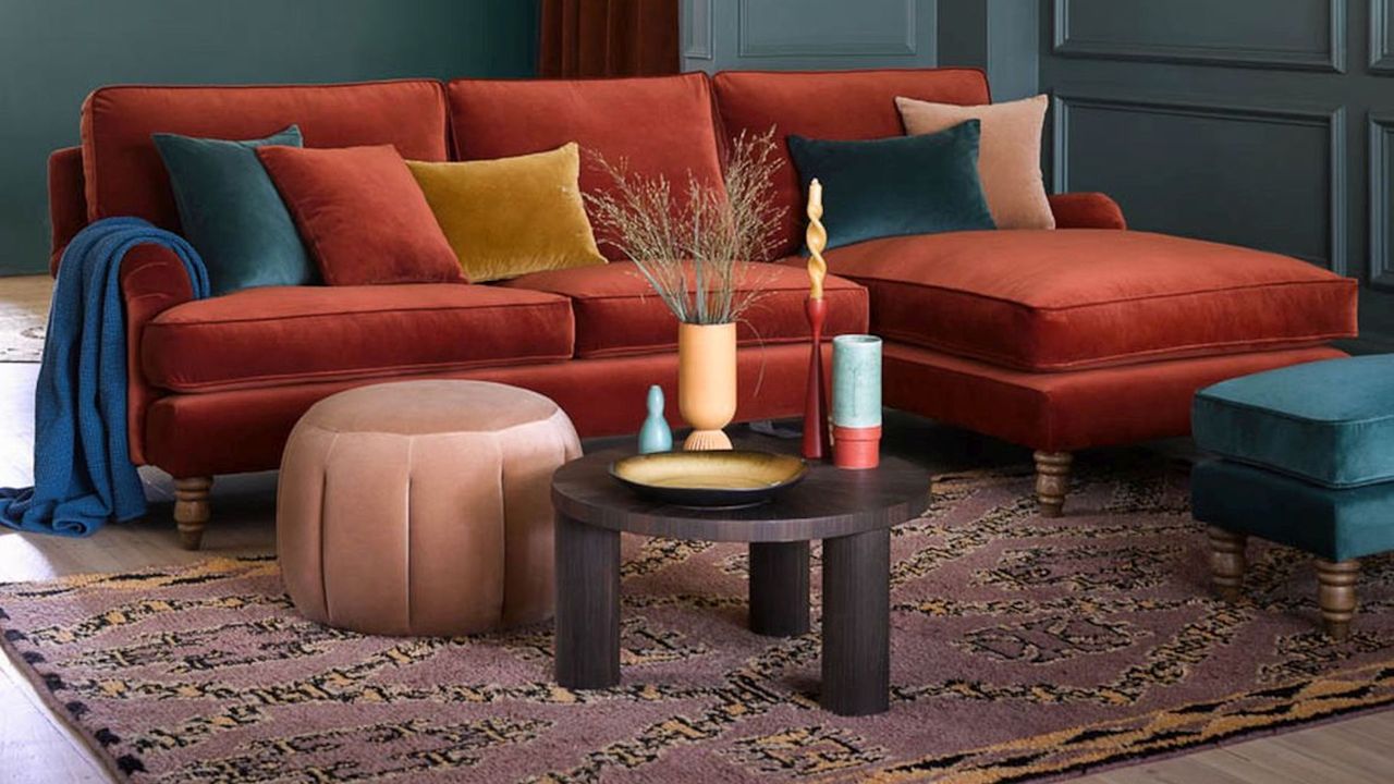 russet sofa and rug with pink pouffe and dark wood coffee table