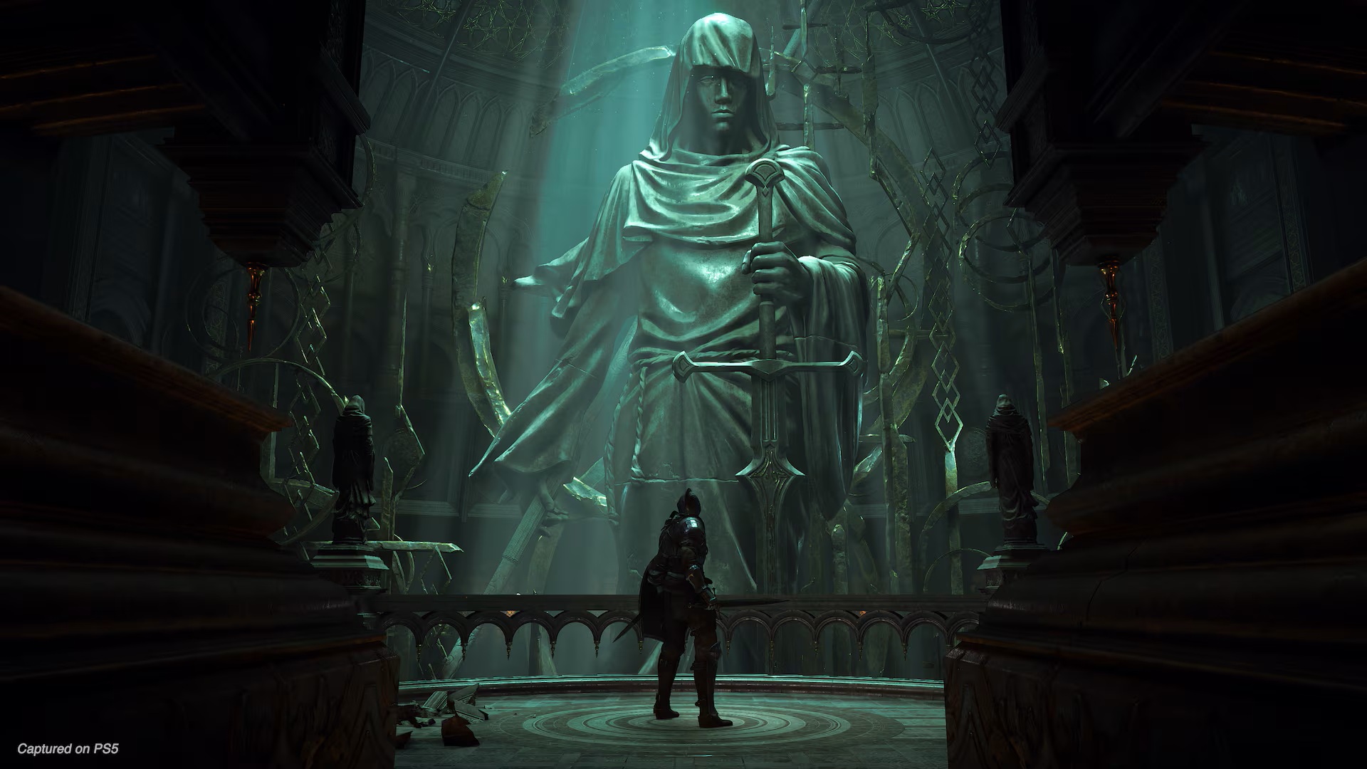 In Demon's Souls on PS5, the Demon Slayer protagonist stands before a statue of a robed woman holding a sword