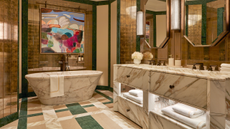 an art deco bathroom in white, cream and green marble with art deco shaped motifs