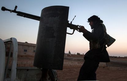 A Kurdish militia member fights in Syria.