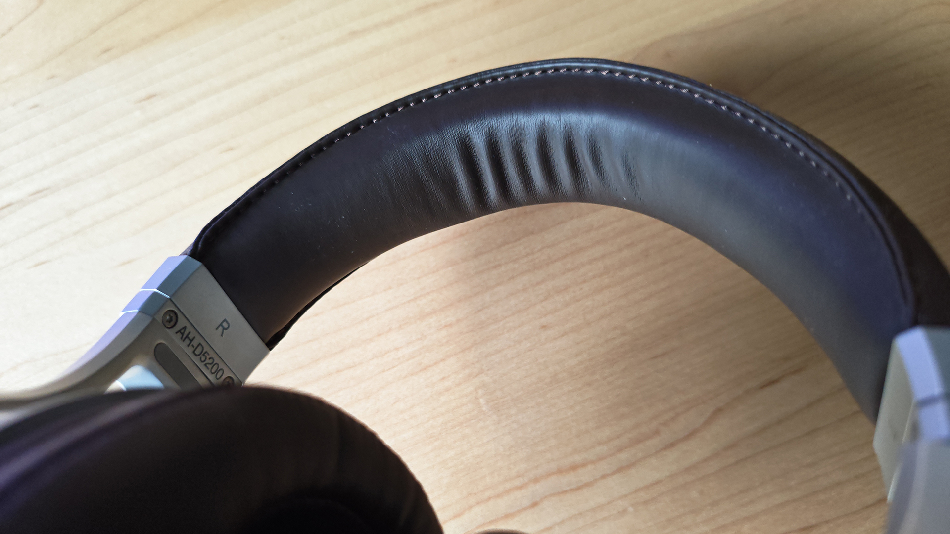 The Denon AH-D5200 and other headphones, photographed on a home desktop. 