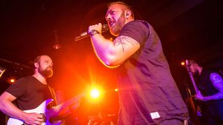 Circus Maximus on stage in Camden against an orange light