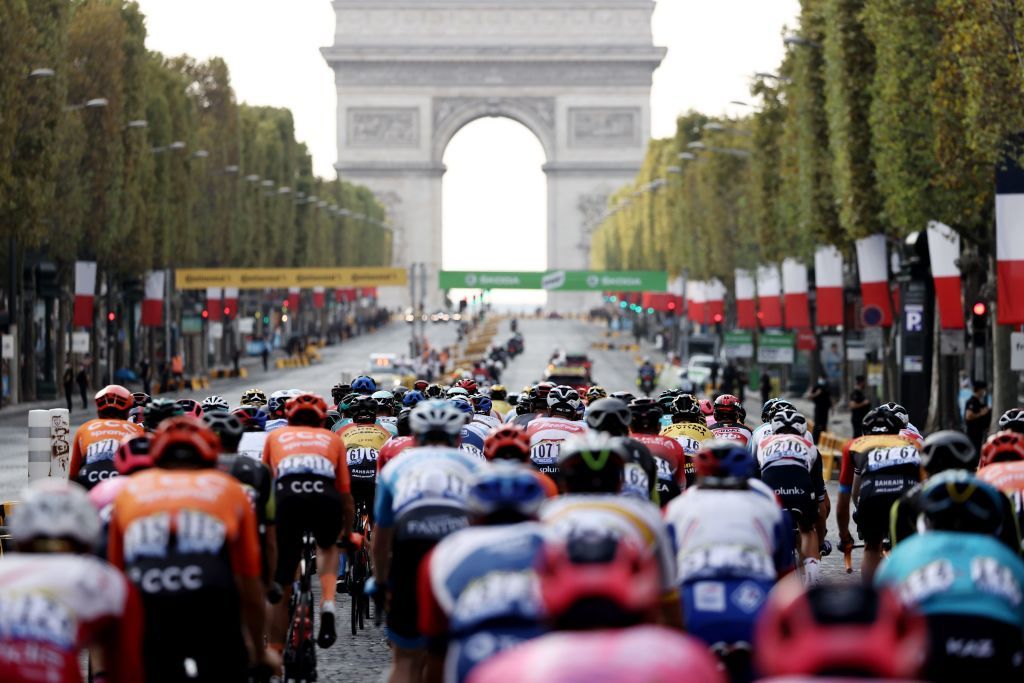 The pack rides on the Champs Elysees avenue with the Arc de Triomphe in the background during the 21st and last stage of the 107th edition of the Tour de France cycling race 122 km between ManteslaJolie and Champs Elysees Paris on September 20 2020 Photo by KENZO TRIBOUILLARD AFP Photo by KENZO TRIBOUILLARDAFP via Getty Images
