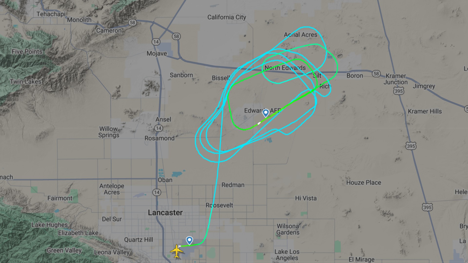 a map of a desert area with a green oval-shaped track overlaid on it