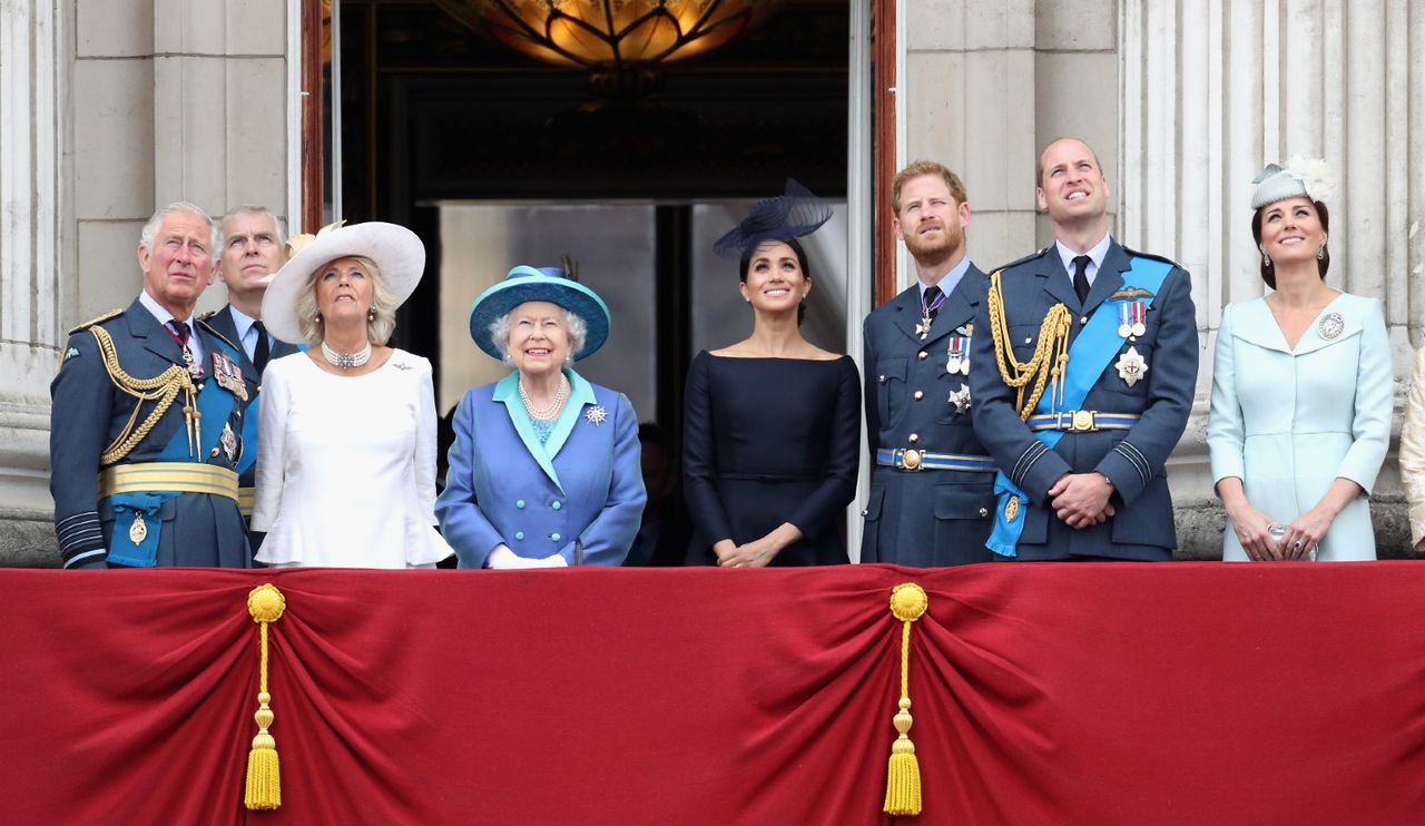 Prince Charles, Prince of Wales, Prince Andrew, Duke of York, Camilla, Duchess of Cornwall, Queen Elizabeth II, Meghan, Duchess of Sussex, Prince Harry, Duke of Sussex, Prince William, Duke of Cambridge and Catherine, Duchess of Cambridge watch the RAF flypast on the balcony of Buckingham Palace, as members of the Royal Family attend events to mark the centenary of the RAF on July 10, 2018 in London, England.