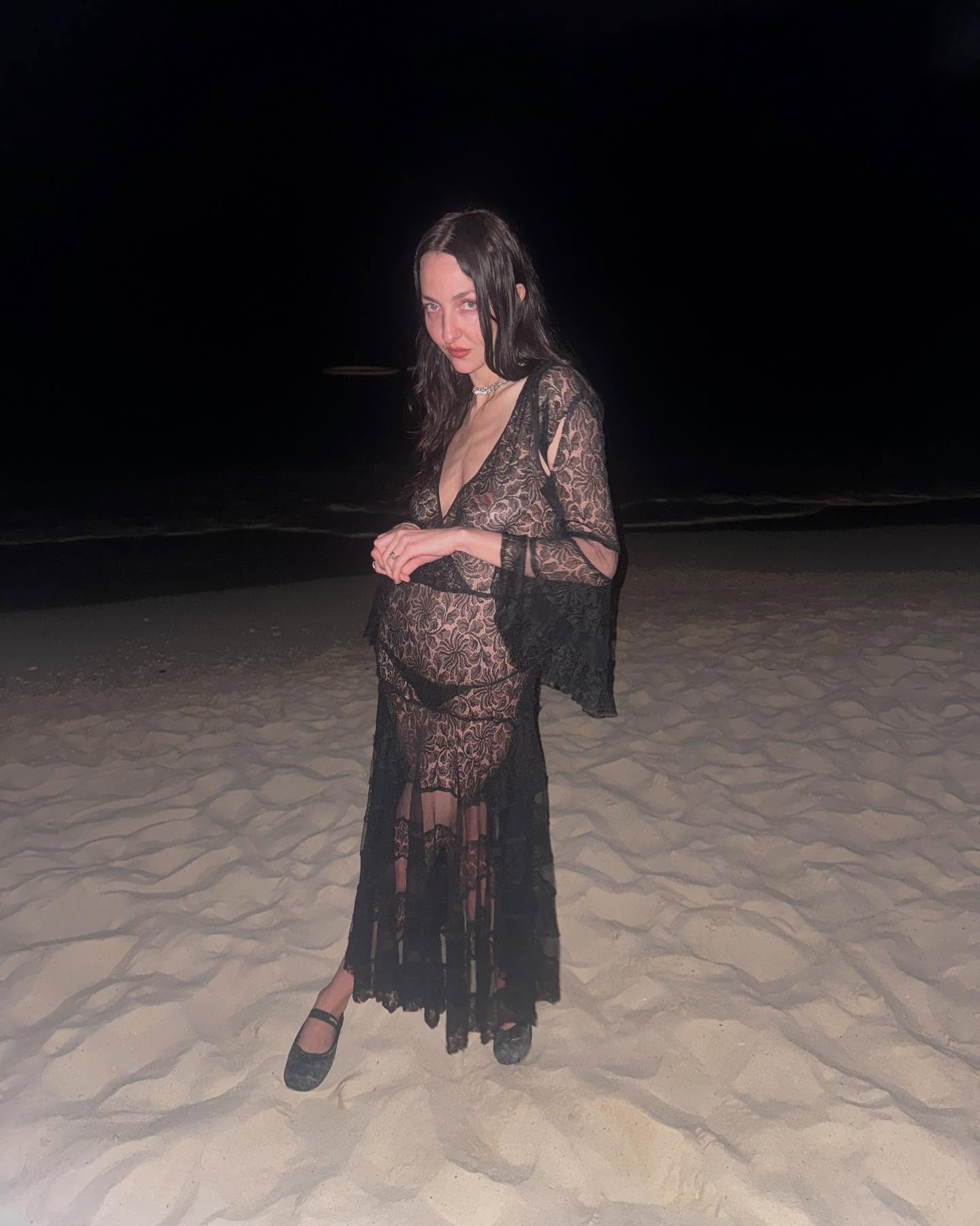 Tish Weinstock wearing black lace on the beach.