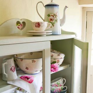 painted cupboard filled with dinner set