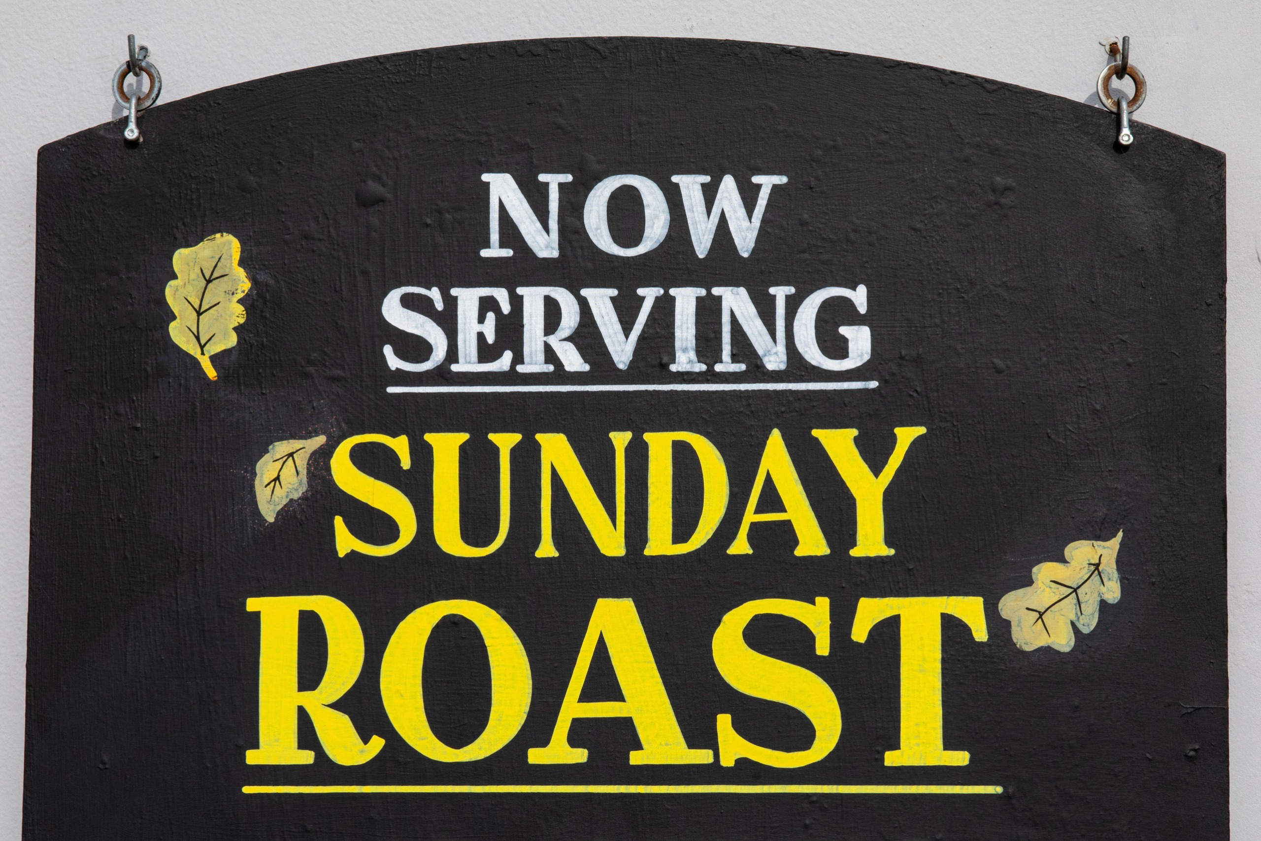 A sign from a pub advertising a roast