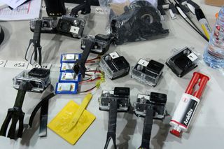 The GoPros and dummy cameras, with a few quick fixes, wait to be fitted to bikes.