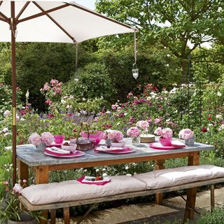 cottage garden with roses and dining table