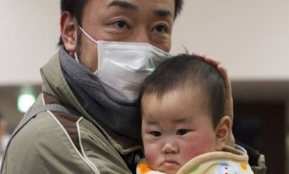 A father holds his feverish son in a Japanese emergency center.