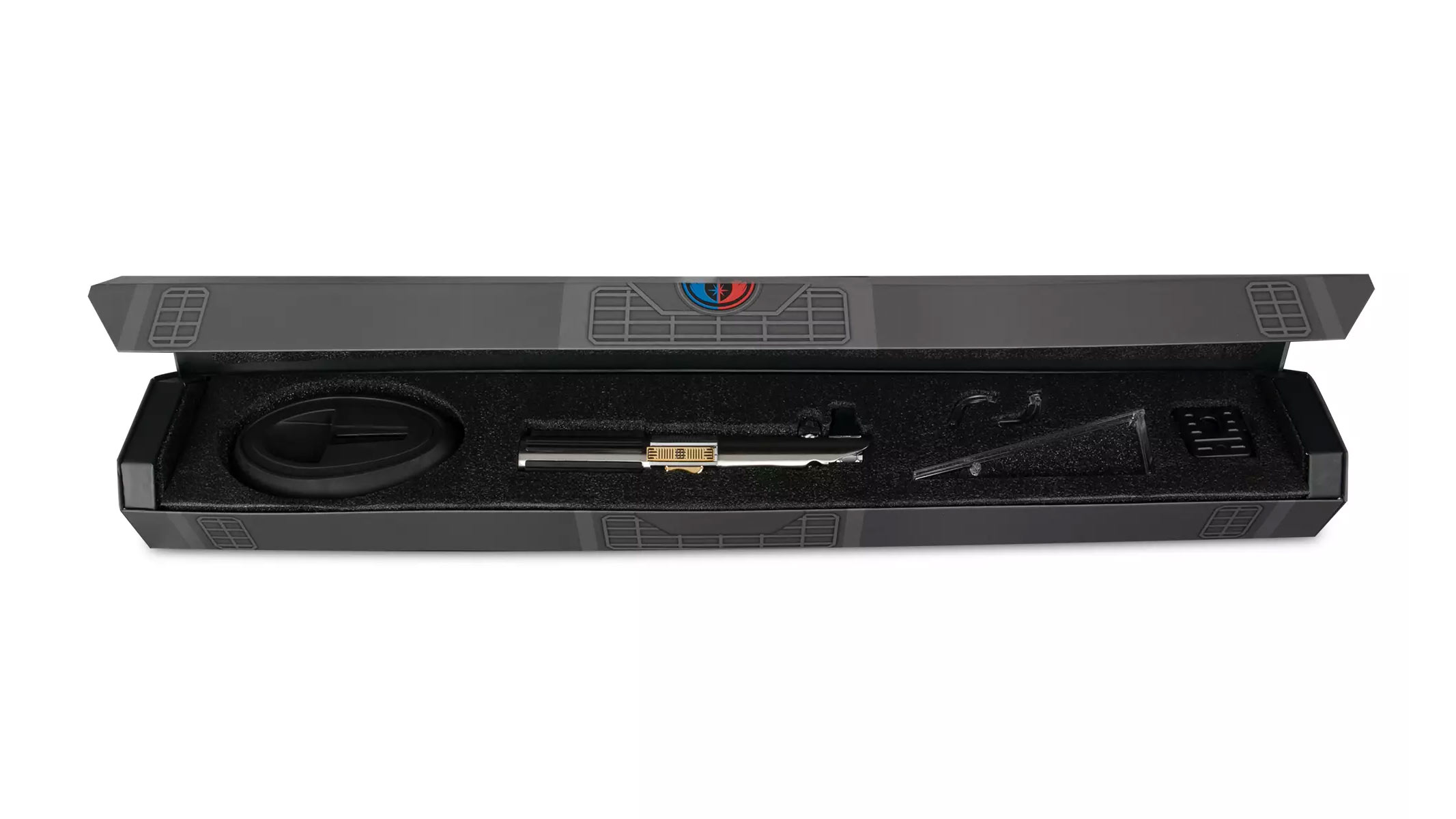 A metal hilt for a lightsaber lies in a case with a black foam protective interior.