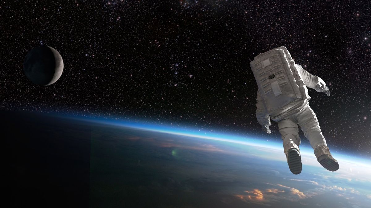 An astronaut floating in space above the Earth with the moon in the background