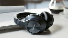 Technics EAH-A800 review: headphones on a table with a book and coffee