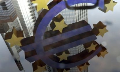The euro symbol is reflected in a puddle in front of the European Central Bank in Frankfurt, Germany: Eurozone leaders meet in Brussels Thursday to decide the monetary system's fate.