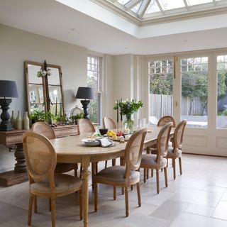 dining area in an orangery with wooden table and traditional chairs