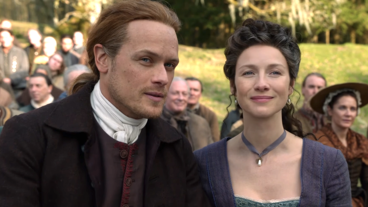 jamie and claire smiling at bree's wedding on outlander