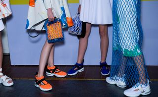 Orange, blue and white colored shoes and handbag.