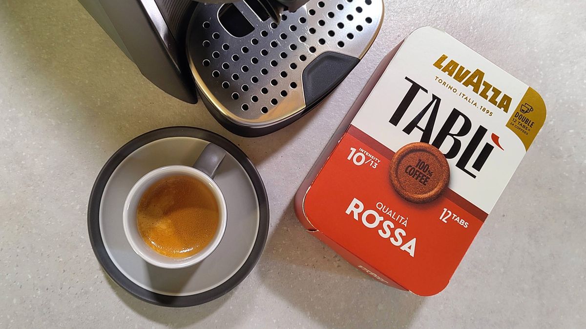 Lavazza Tabli coffee maker with cup of espresso and box of coffee tabs