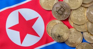 Stock image of the North Korean flag, along with cryptocurrency