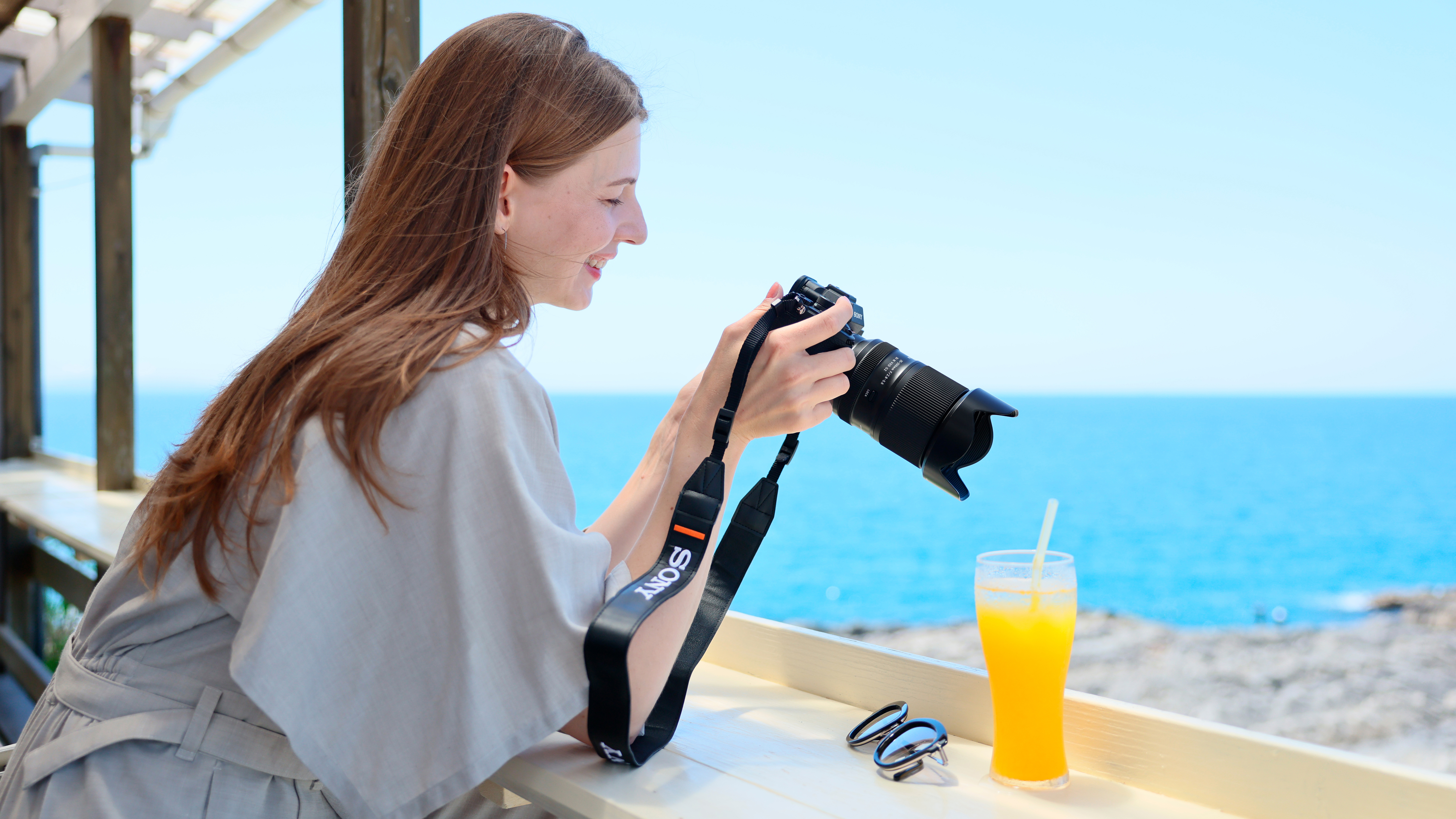 A person holding the Tamron 25-200mm f/2.8-5.6 DI III VXD G2