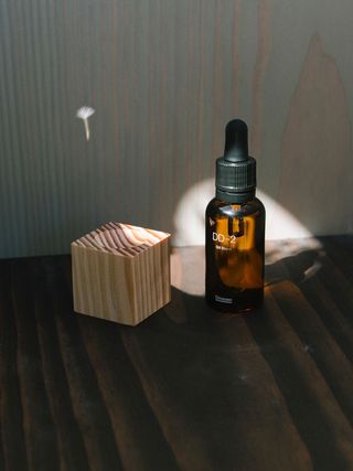 Brown glass bottle with pipette in shadow