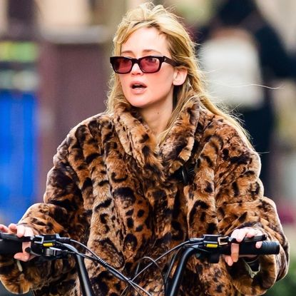 Jennifer Lawrence was spotted on a bike ride in jeans, a leopard fur jacket, and black leather boots