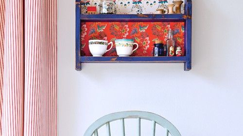 room with white wall with wooden shelves and curtain