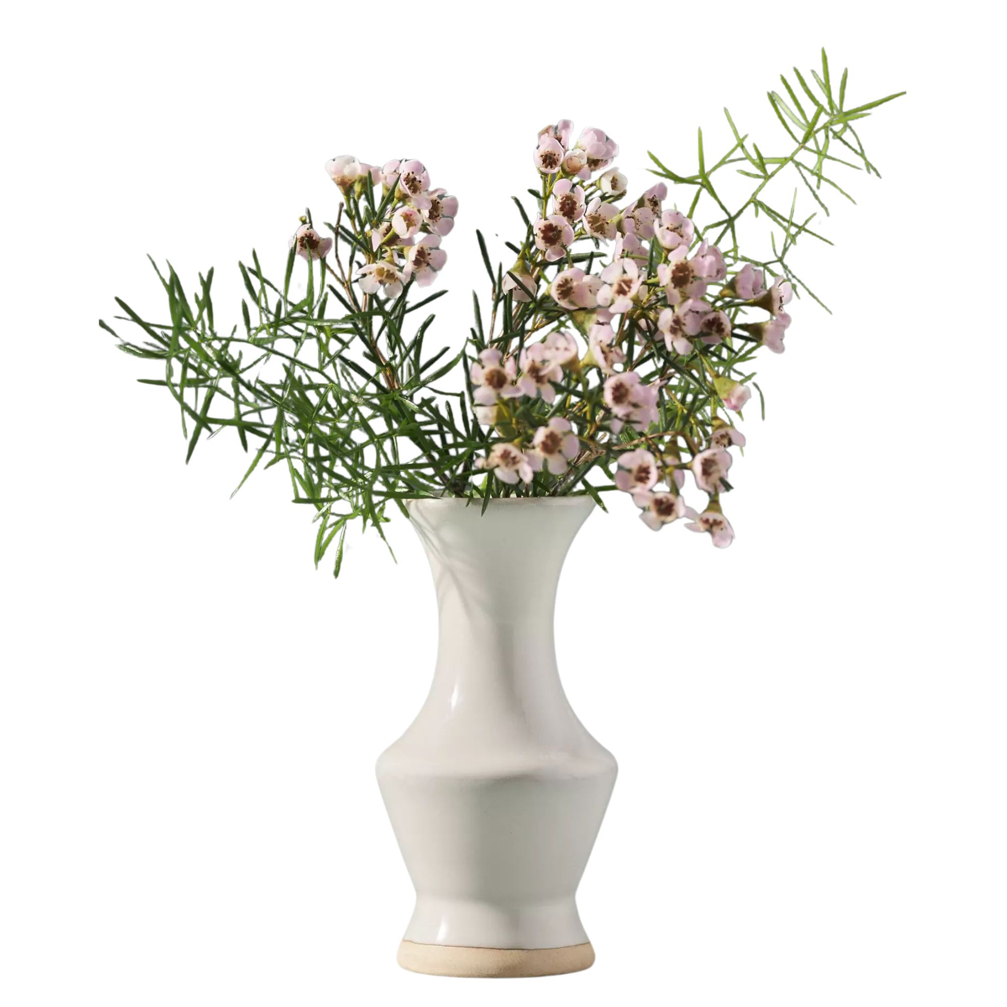 White vase filled with pink flowers and green leaves.