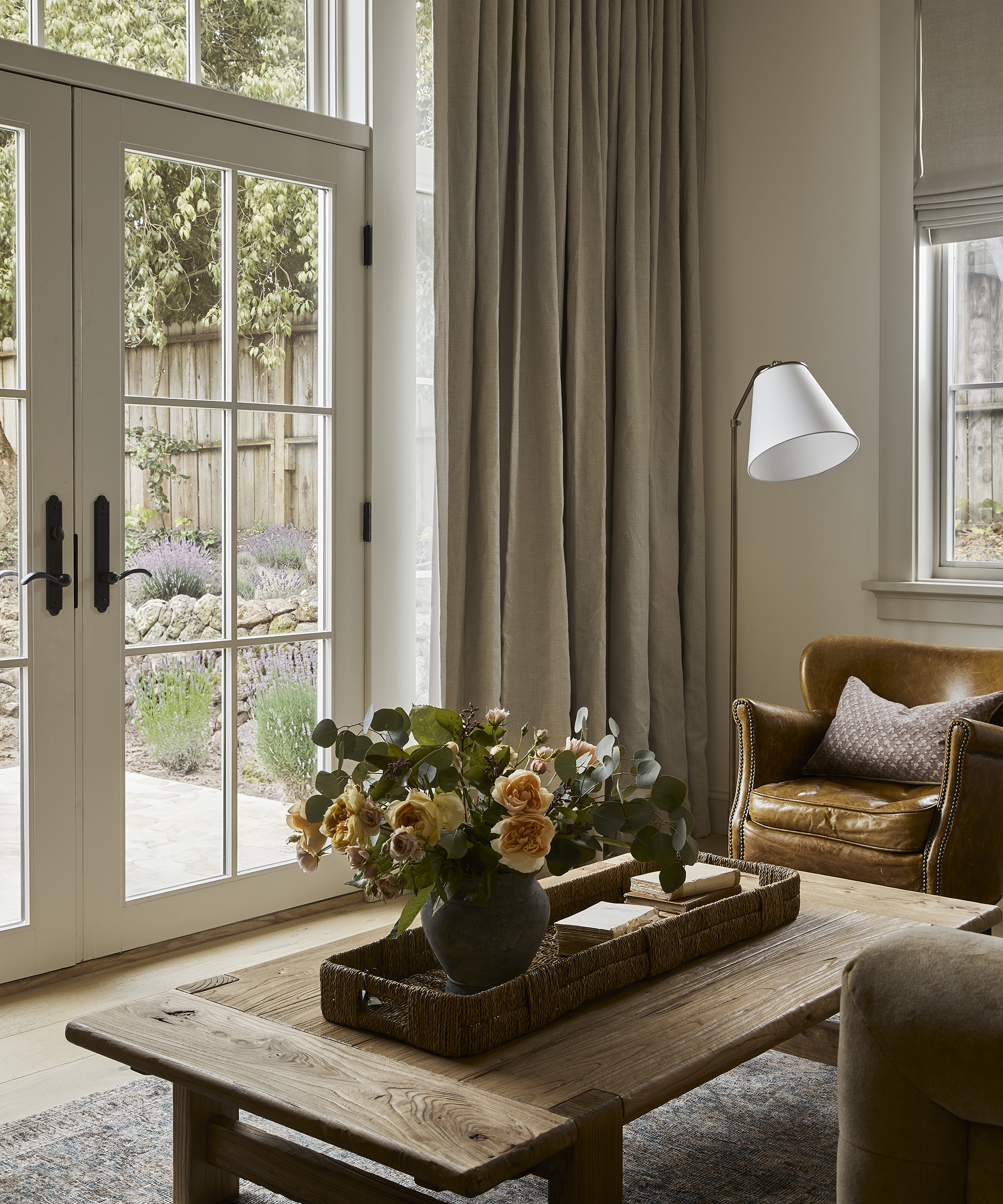 large floral arrangement on a wooden coffee table in a living room