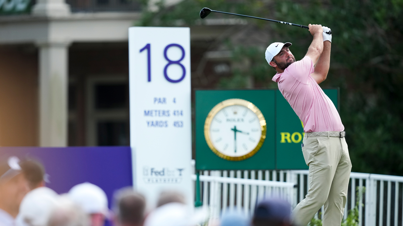 Scottie Scheffler hits a tee shot with a fairway wood