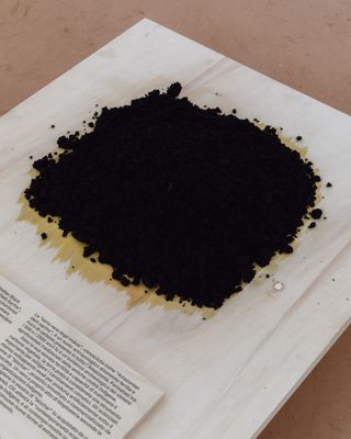 display of heap of black soil in brazil pavilion 2023