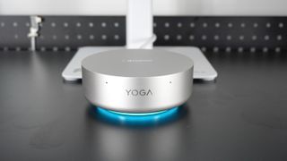The Lenovo Yoga Mini in front of a monitor powered by a single USB-C cable connected to the display