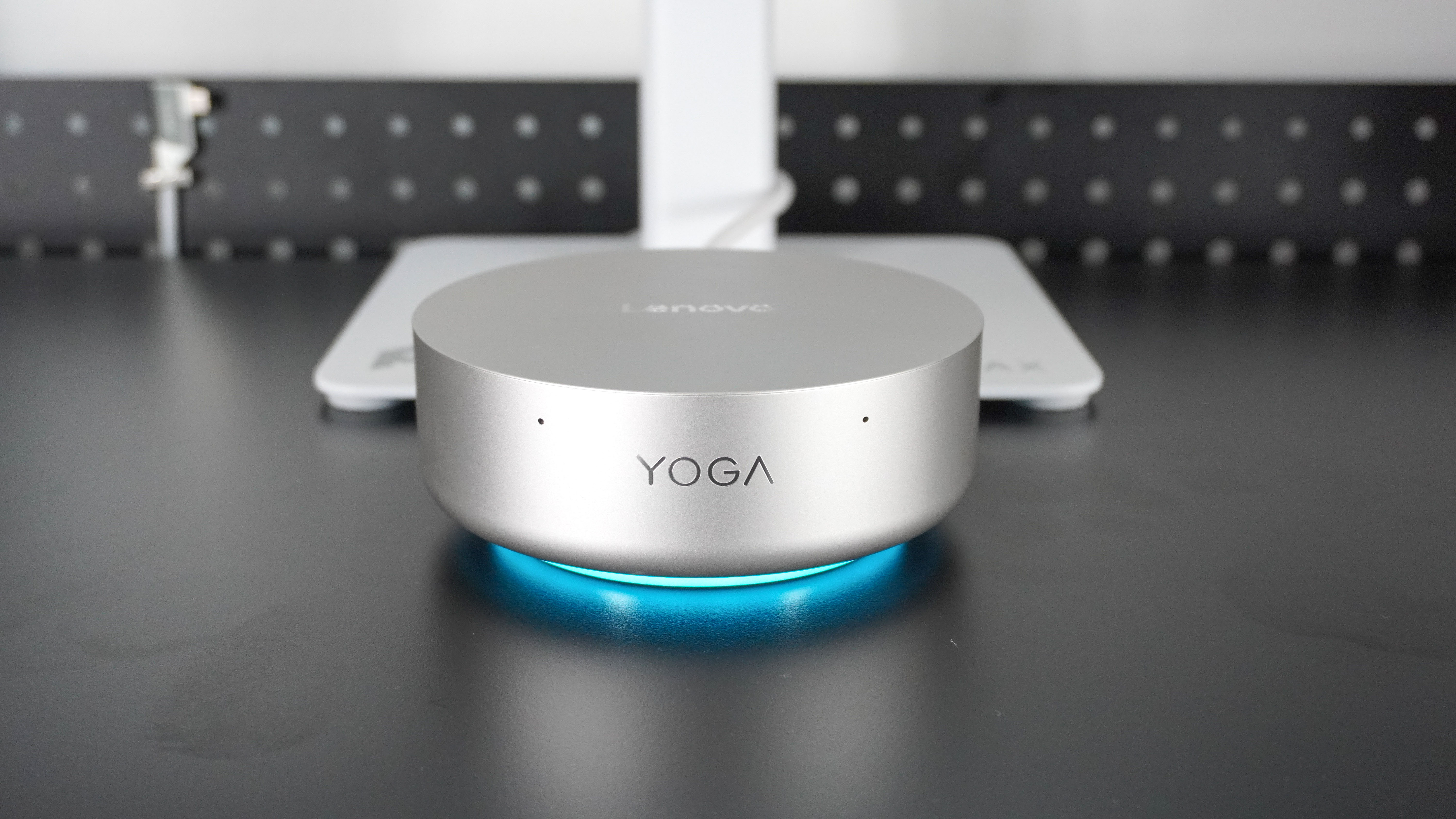 The Lenovo Yoga Mini in front of a monitor powered by a single USB-C cable connected to the display