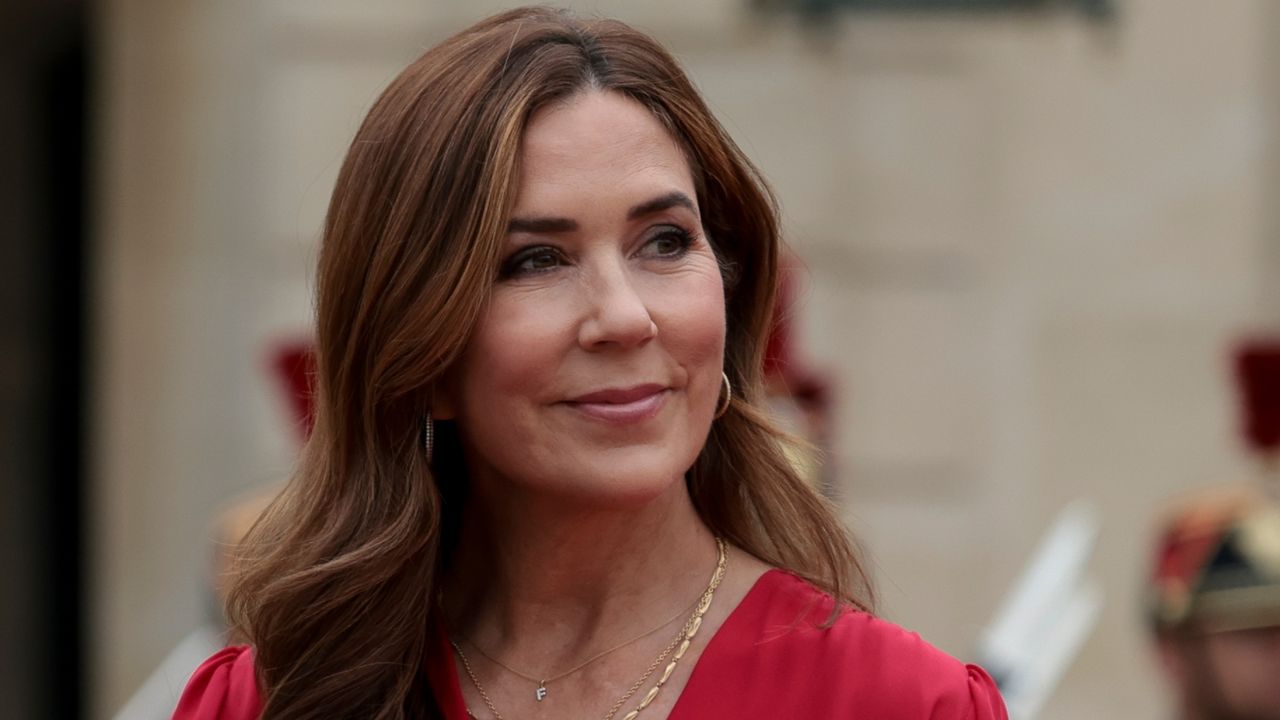 Queen Mary of Denmark wears a red top as she attends a reception for foreign leaders prior to the Olympics Opening Ceremony