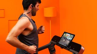 Man running on a treadmill using the Zwift for runners app