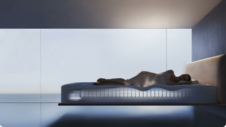 A woman sleeping on her side on an AI mattress that's contouring to her body and lit up beneath her