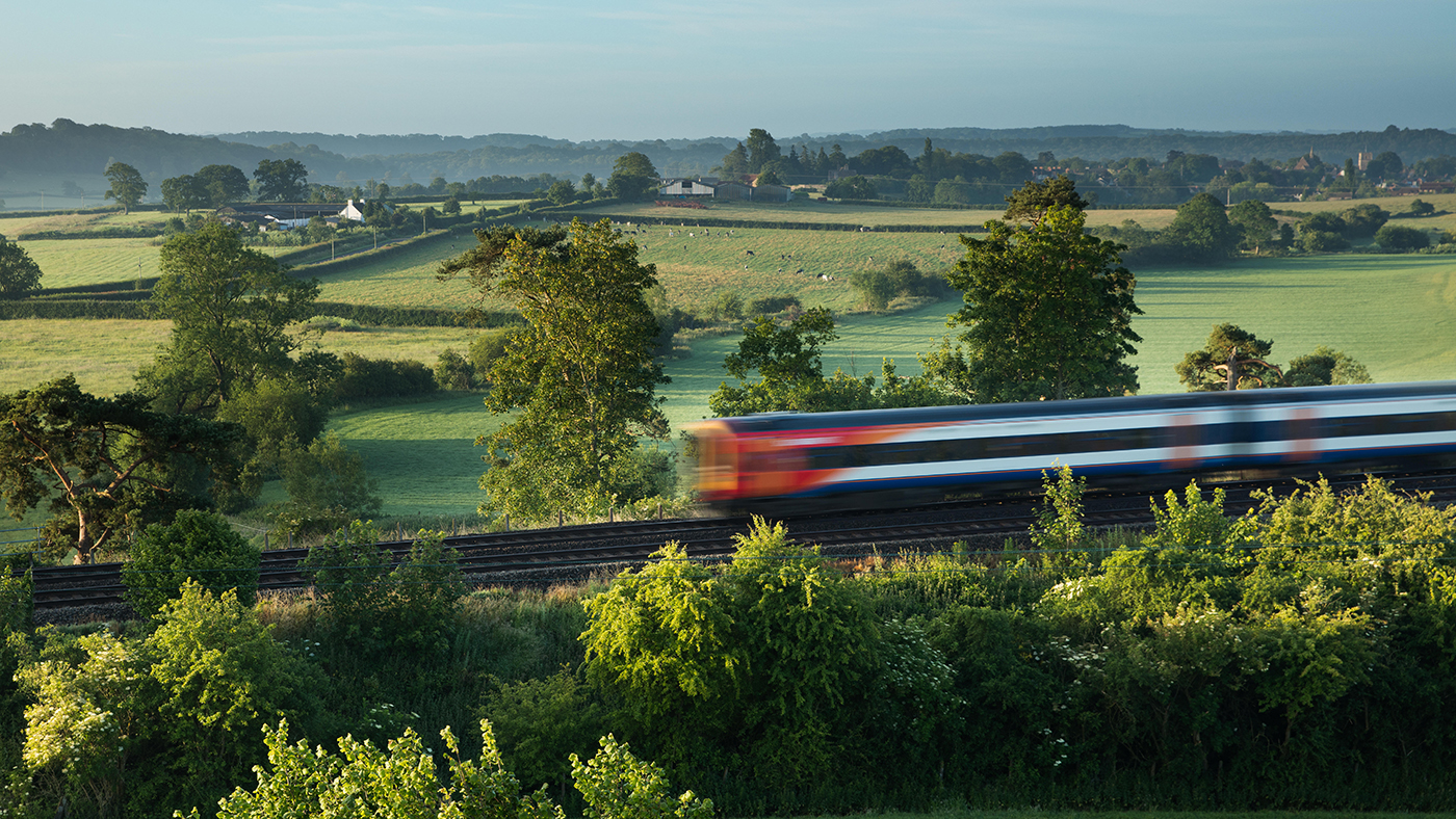 A fast train cutting through British countryside