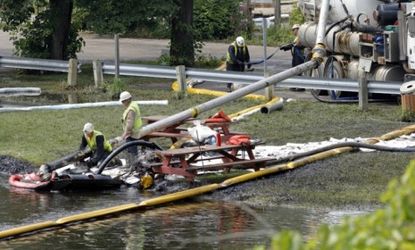 Workers clean up a massive oil spill in Michigan in July 2010: Some researchers say a similar spill would be all but inevitable for Keystone XL.