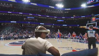 A photo of a person wearing a Quest 3 headset sitting courtside at an NBA game, with the players visible.