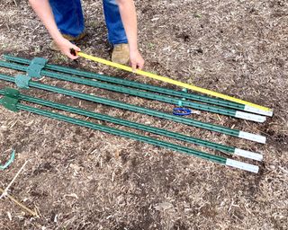 Man measuring T-posts