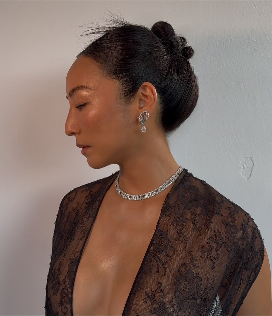 Greta Lee with feathery topknot updo