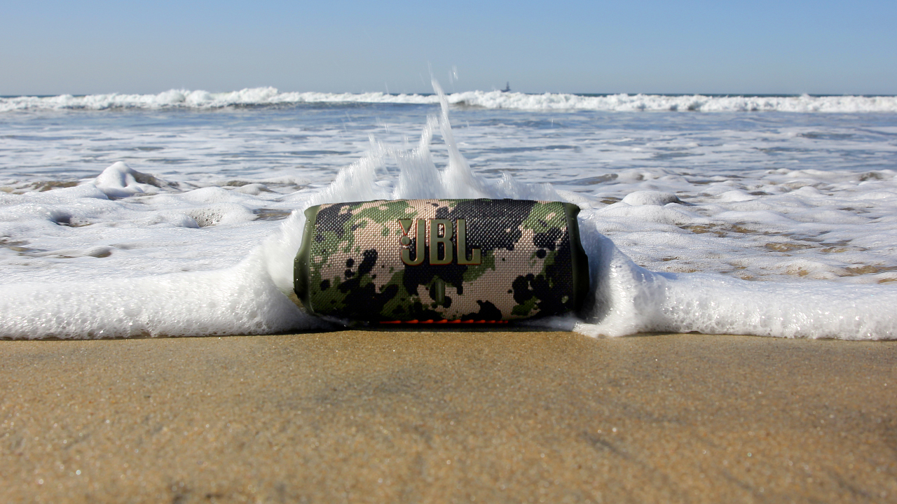 the JBL Charge 5 bluetooth speaker on a beach