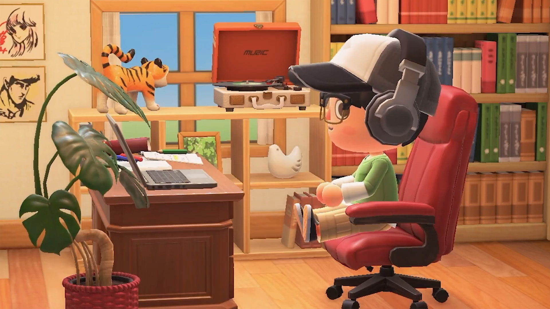An Animal Crossing player sits on a computer chair at a desk with a laptop on. They are wearing headphones