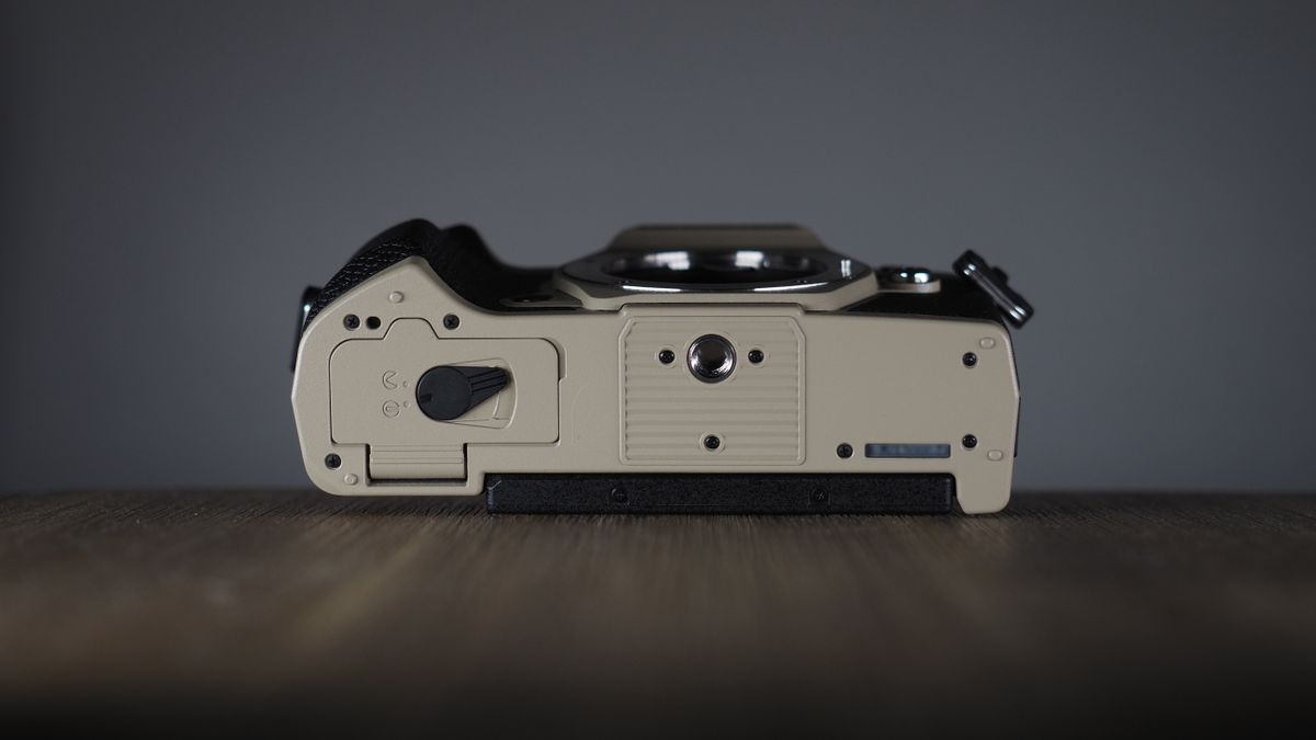 OM System OM-5 Mark II on a wooden surface with an Olympus M.Zuiko 12-45mm lens
