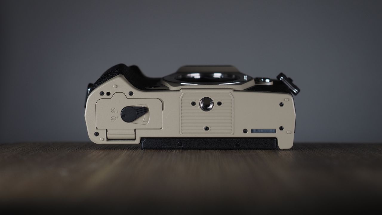 OM System OM-5 Mark II on a wooden surface with an Olympus M.Zuiko 12-45mm lens
