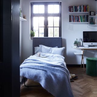 Arlo & Jacob bed in a box in a guest bedroom, with a desk with a Mac on top: one of the best garage conversion ideas