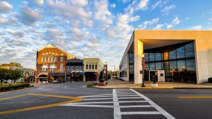 The town of Somerset, Kentucky, with the sun shining in over a modern and a more traditional building.