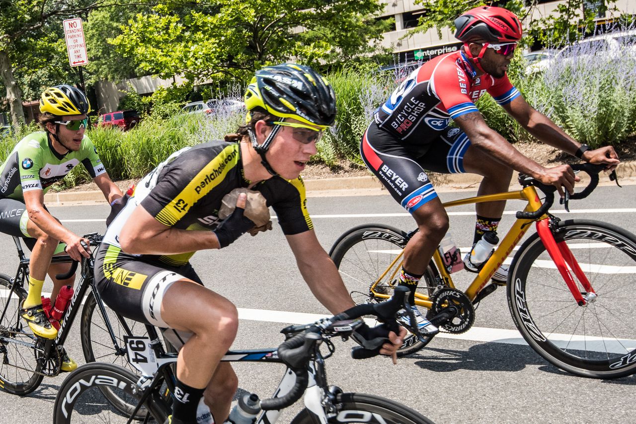 A rider takes an ice hand up during todays hot race